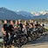 14 smiling people standing beside their electronic bikes at the edge of a lake on North Douglas Island in Alaska